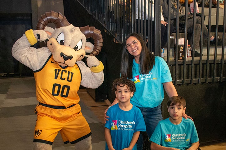 CHoR's Patient Champion, Jonah Smith, and his family pose with VCU's Rodney the Ram