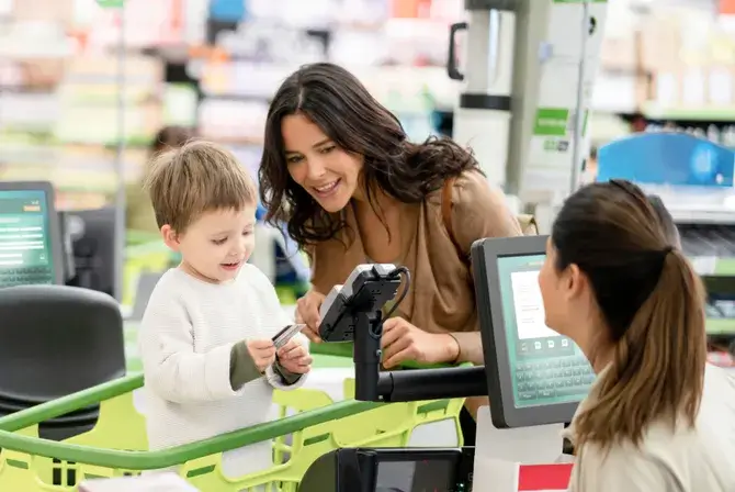 Mother with child at a checkout counter