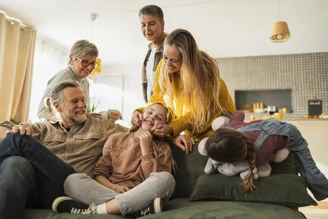 multi-generational family laughing together and smiling