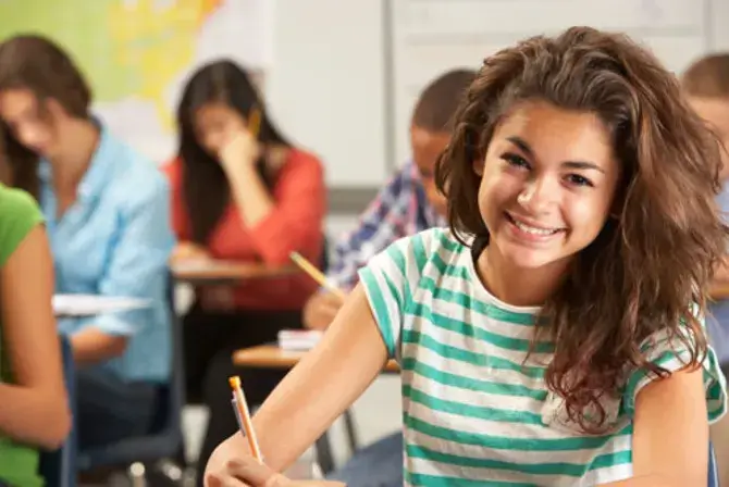 A young student in a classroom.