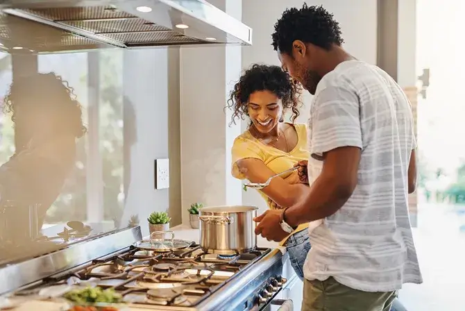 Couple cooking dinner in kitchen