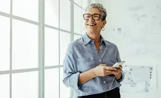 Woman smiling and looking at her phone