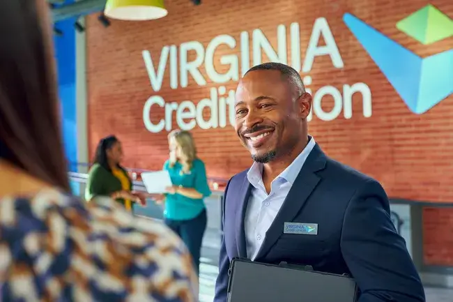 A Virginia Credit Union employee greeting an individual in a branch