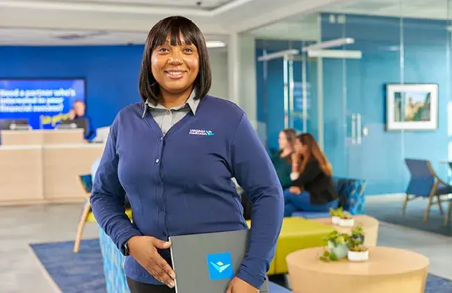 Virginia Credit Union employee smiling while working in a branch