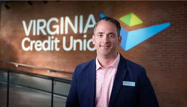 A Virginia Credit Union employee greeting an individual in a branch
