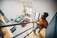 Man standing on stairs of their new condo