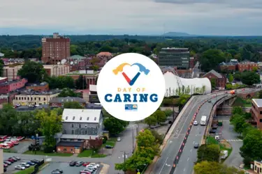 Overhead shot of city landscape with Charlottesville's Day of Caring logo