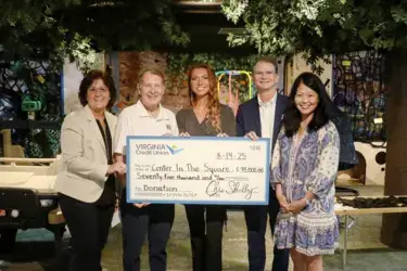 VACU and its Member One division employees smiling while presenting check to Kids Square Children's Museum