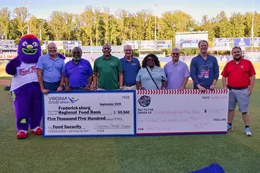 Virginia Credit Union (VACU) and the Fredericksburg Nationals team present check donation to local food bank