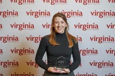 Jessica Barile pictured smiling and holding In-House Counsel Award presented by Virginia Lawyers Weekly and Virginia Business
