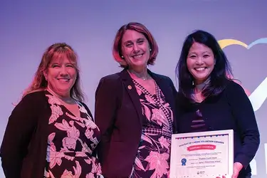 Virginia Credit Union employees smile while accepting award Day of Caring Community Champion Award by United Way of Greater Charlottesville.